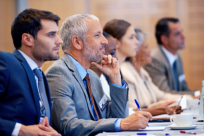Buy stock photo Shot of a group of people sitting in a conference