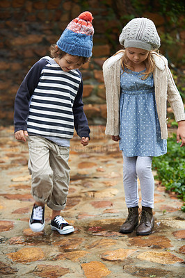 Buy stock photo Full length shot of two cute kids going for a walk in their garden on an autumn day