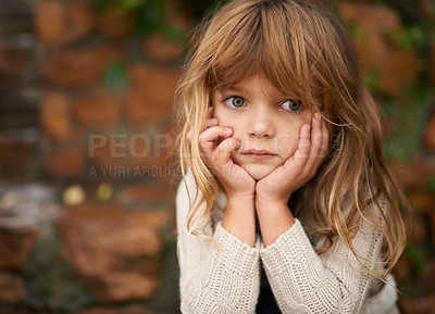 Buy stock photo Cropped shot of a cute little girl sitting outside on an autumn day