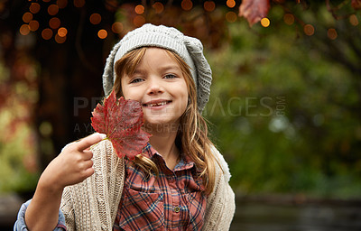 Buy stock photo Happy, leaf and portrait of child in park with smile for playing, freedom and adventure outdoors. Childhood, happiness and young girl with plants in nature for playing, relaxing and fun in autumn