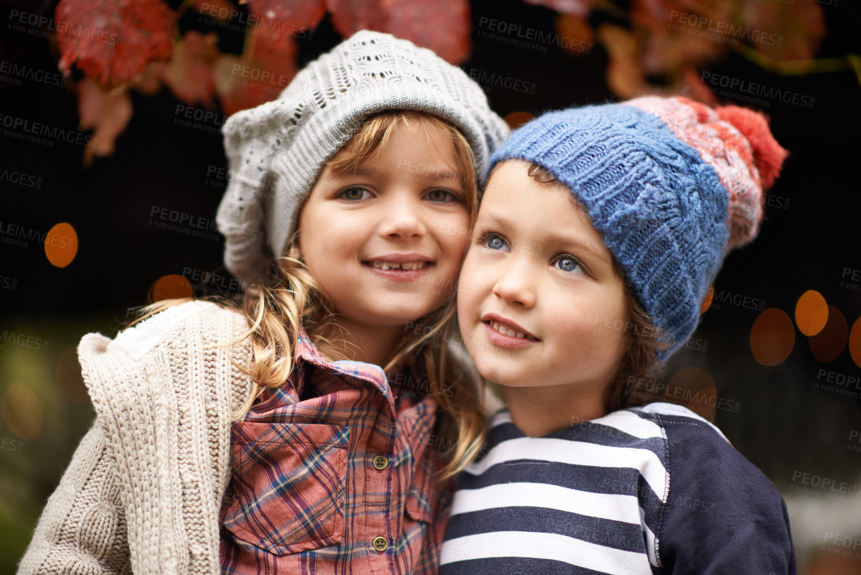 Buy stock photo Portrait of a cute brother and sister standing outdoors on an autumn day