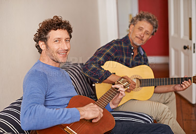 Buy stock photo Happy man, portrait and relax with family, guitar or music for acoustic sound or instruments at home. Young man playing or strumming with smile and father for classical audio on living room sofa