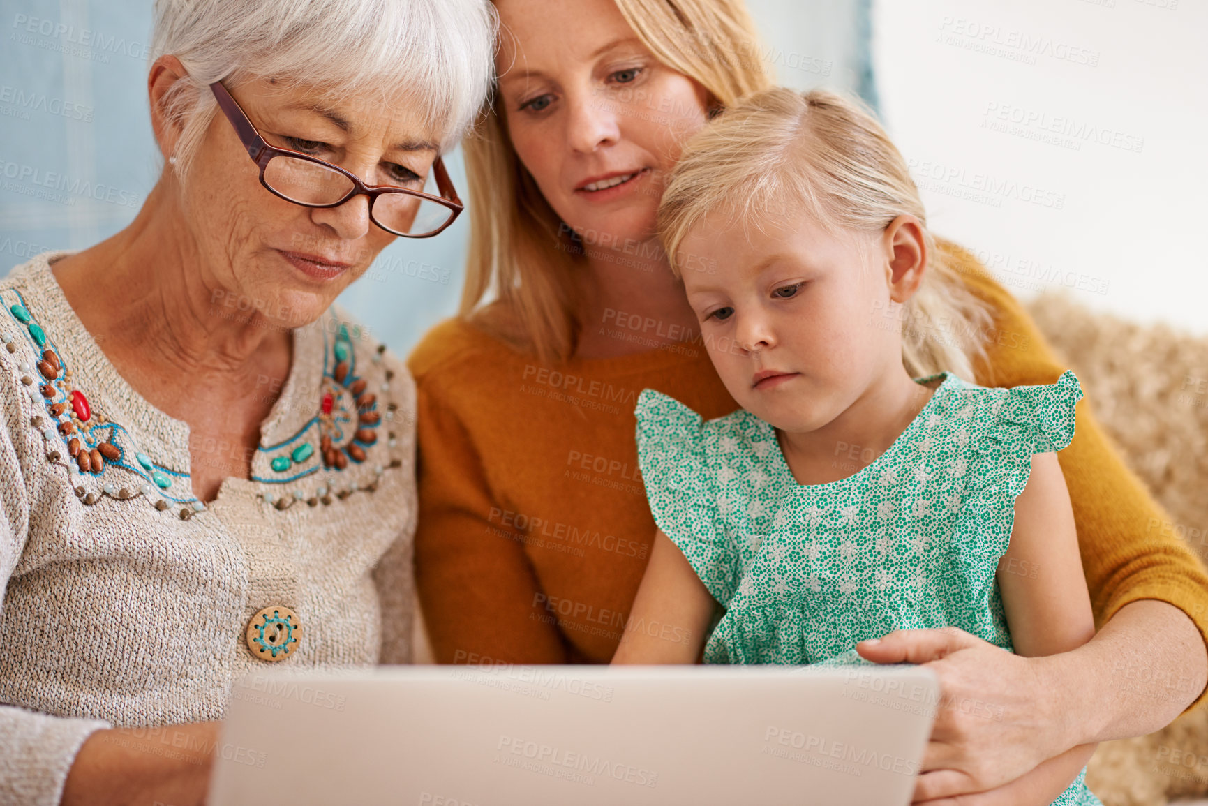 Buy stock photo Family, laptop and internet at a home with grandmother, girl and mother together with game. Learning, online and senior woman with child and mom with love, support and care in a house with tech