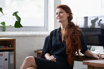 Buy stock photo Shot of a beautiful young businesswoman sitting at her desk