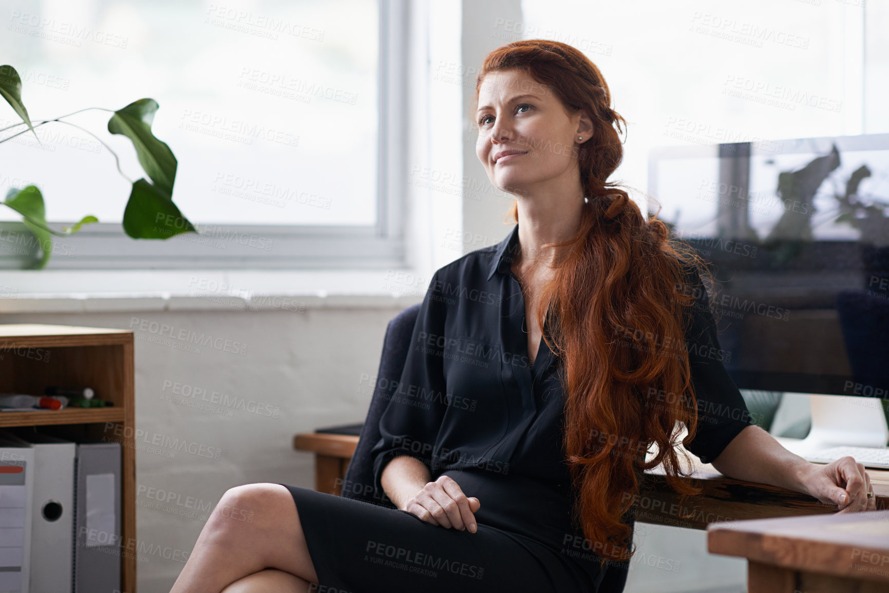 Buy stock photo Shot of a beautiful young businesswoman sitting at her desk