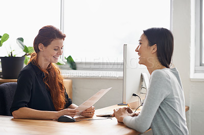 Buy stock photo Resume, job interview and business women in office in conversation, talking and discussion at desk. Communication, partnership and female workers with paperwork for recruitment, cv and hiring review
