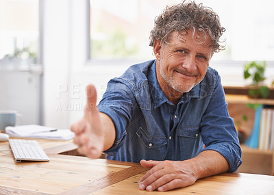 Buy stock photo Portrait of a mature businessman extending his arm for a handshake