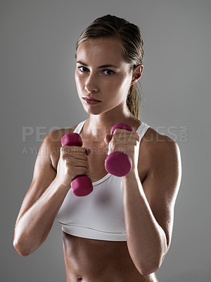 Buy stock photo Serious woman, portrait and workout with dumbbells for fitness, weightlifting or exercise on a gray studio background. Female person, bodybuilder or athlete with small barbells for training on mockup