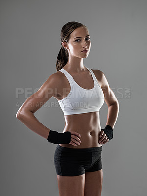 Buy stock photo Shot of an athletic woman in workout clothes standing with her hands on her hips
