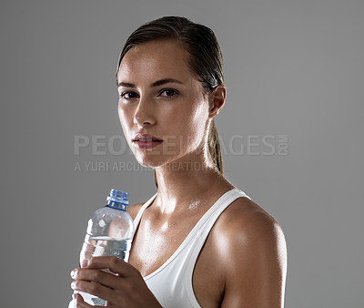 Buy stock photo Woman, portrait and fitness with water bottle for hydration, sweat or workout on a gray studio background. Face of female person or athlete with liquid or drink for exercise in health and wellness