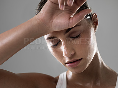 Buy stock photo Shot of an attractive woman looking tired after a good workout