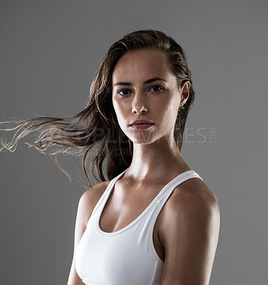 Buy stock photo Woman, serious in portrait and confidence for fitness, strong and determined with sweat from workout on grey background. Hair in wind, athlete for sports and exercise with pride and power in studio
