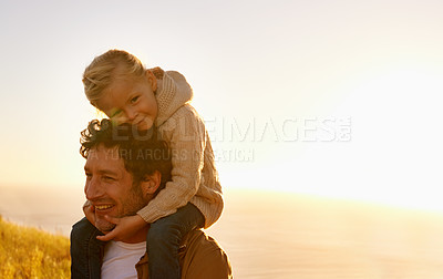 Buy stock photo Cropped shot of a father giving his little girl a ride on his shoulders while on a walk in nature
