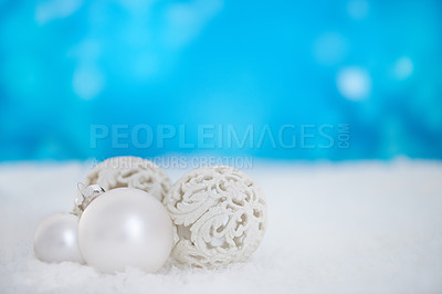 Buy stock photo Some christmas baubles lying on a bed of snow