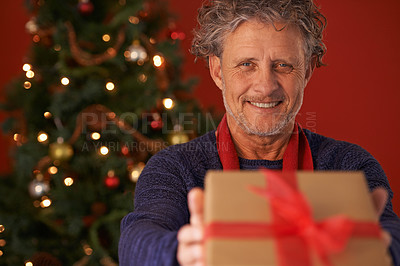 Buy stock photo Senior man, portrait and Christmas tree with gift box for present, giving or December holiday at home. Happy male person with smile for wrapped container, festive season or ribbon of Santa at house