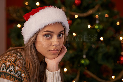 Buy stock photo Woman, portrait and hat by Christmas tree at night, relax and lounge for festive season in home. Female person, face and ready for event or party on religious holiday, xmas fashion and winter style