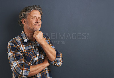 Buy stock photo Mature, thinking and man planning in studio on dark background with fashion or casual style. Confident, person and smile on face with ideas for future on mockup space with plaid pattern on shirt