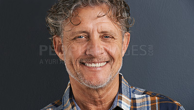 Buy stock photo A cropped portrait of a happy mature man standing against a grey background