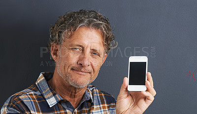 Buy stock photo Mature, man and portrait with cellphone screen in studio for texting communication, grey background or website. Male person, face and smartphone for online internet or browse, display or mockup space