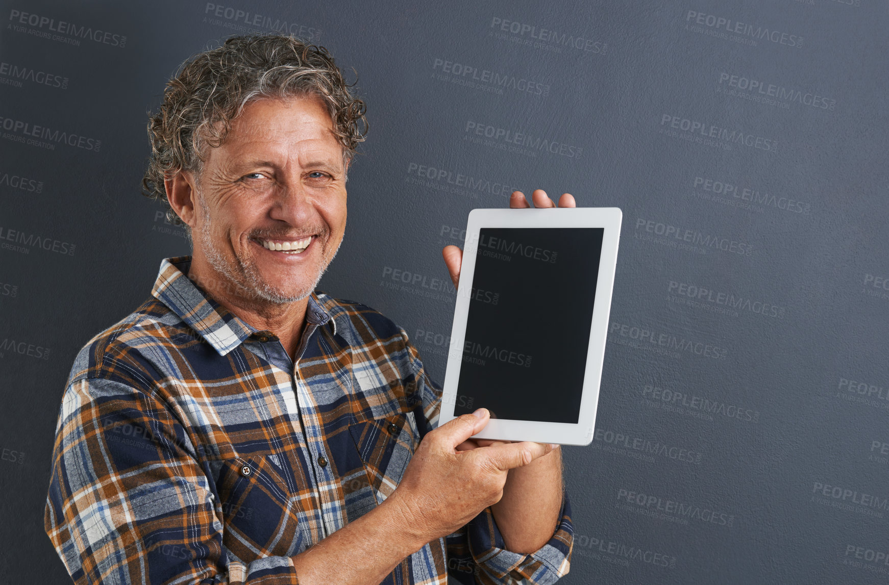 Buy stock photo Tablet, screen and portrait of mature man in studio and learning about technology on dark background. Advertising, tech and mockup with post online to social media and person search internet for news