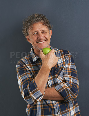 Buy stock photo A portrait of a happy mature man holding a delicious apple