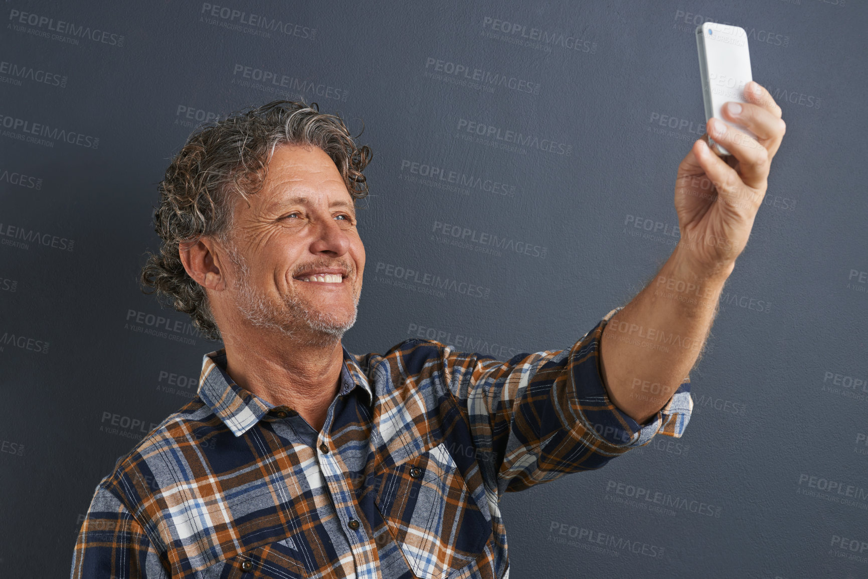 Buy stock photo Mature, man and happy selfie in studio and learning about photography on dark background. Filming, video or click record for profile picture and post online to social media with website or blog