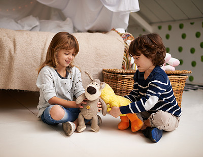 Buy stock photo Shot of two adorable siblings playing together with their stuffed animals