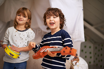 Buy stock photo Portrait of two adorable siblings playing with their musical toys