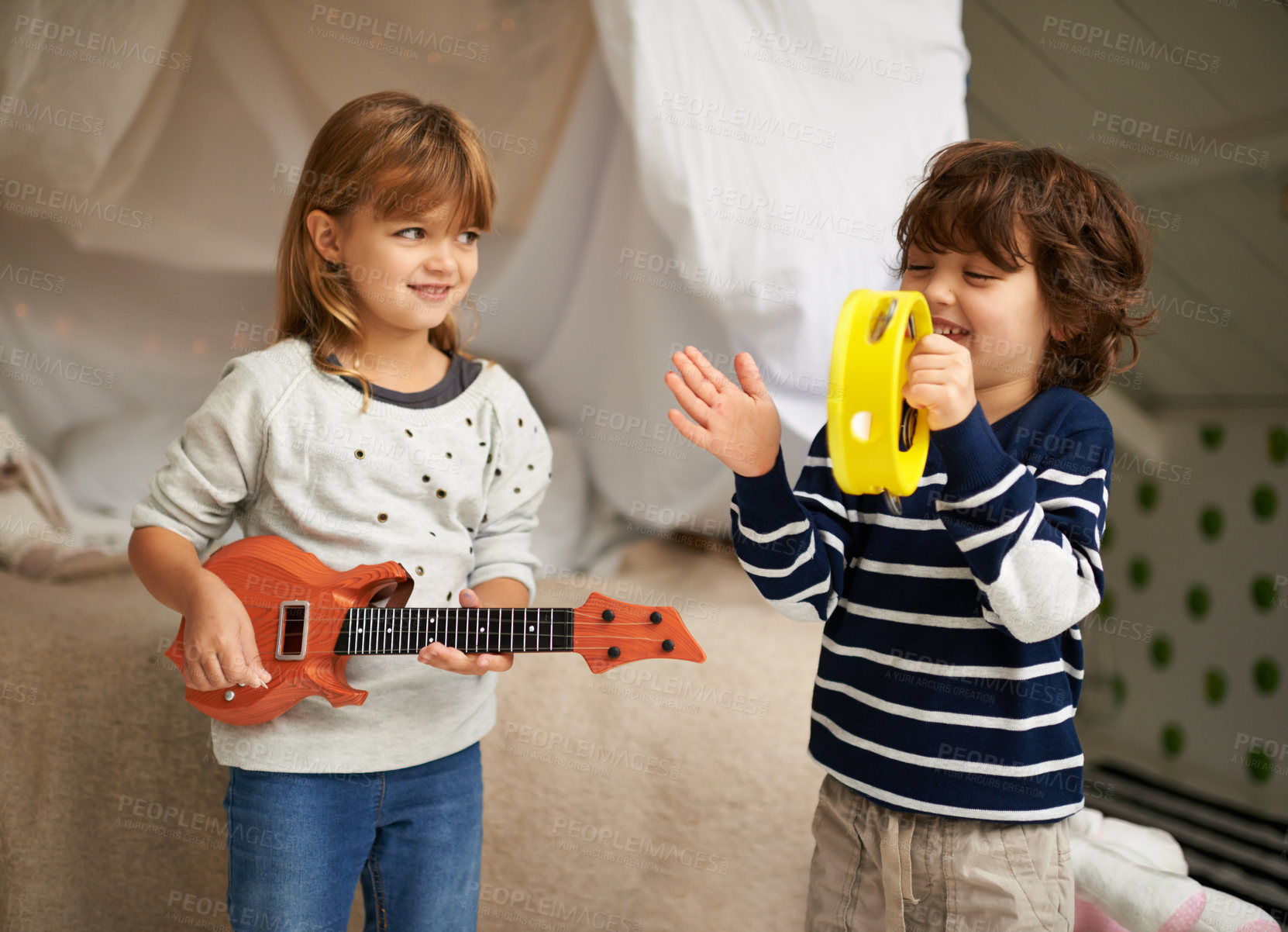 Buy stock photo Music, playing and children with instruments in bedroom for fun, bonding and band practice. Happy, smile and young girl and boy kids with guitar and tambourine toys enjoying musical song at home.