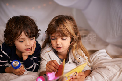 Buy stock photo Reading, blanket fort and children with book for knowledge, learning and education with flashlight. Bonding, relaxing and young kids enjoying story or novel together in tent for sleepover at home.