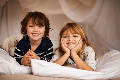 Buy stock photo Smile, blanket fort and portrait of children relaxing, bonding and playing together at home. Happy, cute and young girl and boy kid siblings laying in tent for fun sleepover in bedroom at house.