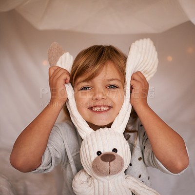 Buy stock photo Portrait of an adorable little girl playfully holding her toy rabbit