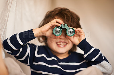 Buy stock photo Shot of an adorable little boy playing with a pair of binoculars