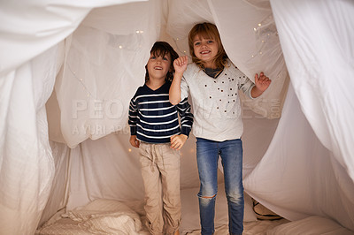 Buy stock photo Happy, blanket fort and portrait of children standing, bonding and playing together at home. Smile, cute and young girl and boy kid siblings jumping in tent for fun sleepover in bedroom at house.