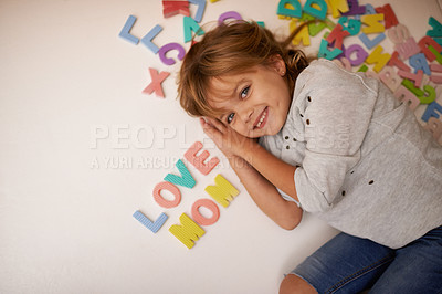 Buy stock photo Girl, letter toys and love mom with English and learning for development, games and smile in playroom at family home. Portrait, education and growth in childhood with alphabet, language and happiness
