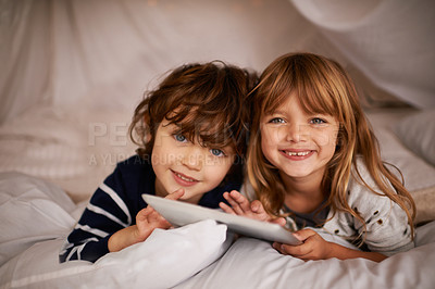 Buy stock photo Tablet, blanket fort and portrait of kids relaxing, bonding and playing together at home. Happy, smile and young girl and boy children siblings laying in tent for fun sleepover in bedroom at house.