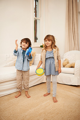 Buy stock photo Home, portrait and tambourine with boy and girl for fun, childhood and bonding together for family with music game. Children, siblings and play in living room with smile for noise and entertainment.