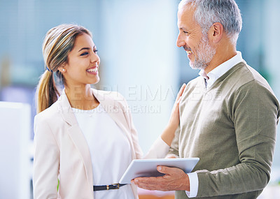 Buy stock photo Shot of two business colleagues having a discussion at the office