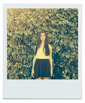 Buy stock photo Bush, leaves and portrait of girl in nature for peace, zen and relax outdoors on polaroid. Female person, teenager and fashion in garden for trendy, style and summer vacation with serious face