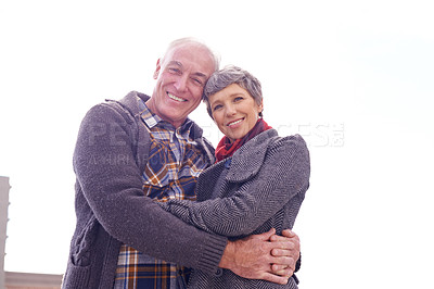 Buy stock photo Portrait of a happy senior couple enjoying an affection filled moment outdoors