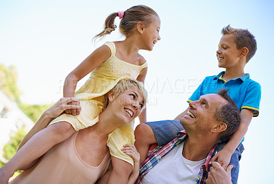 Buy stock photo Smile, parents and carrying children in park, shoulders and quality time in nature. Love, fun and joyful with happy mother and father on holiday relax, spring and carefree with family on vacation 