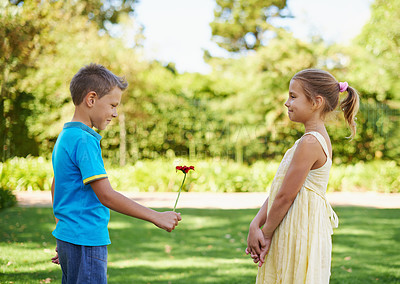 Buy stock photo Boy, girl and flower present or outdoor connection with love kindness for young friendship, bonding or innocent. Children, smile and backyard garden for giving gift for summer holiday, play or park