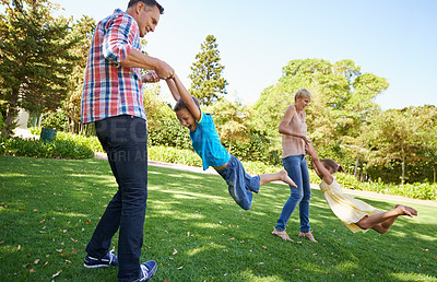 Buy stock photo Parents, children and spinning fun in garden for bonding game together on park field for summer, recreation or connection. Mother, father and siblings with laugh on backyard grass, family or carefree