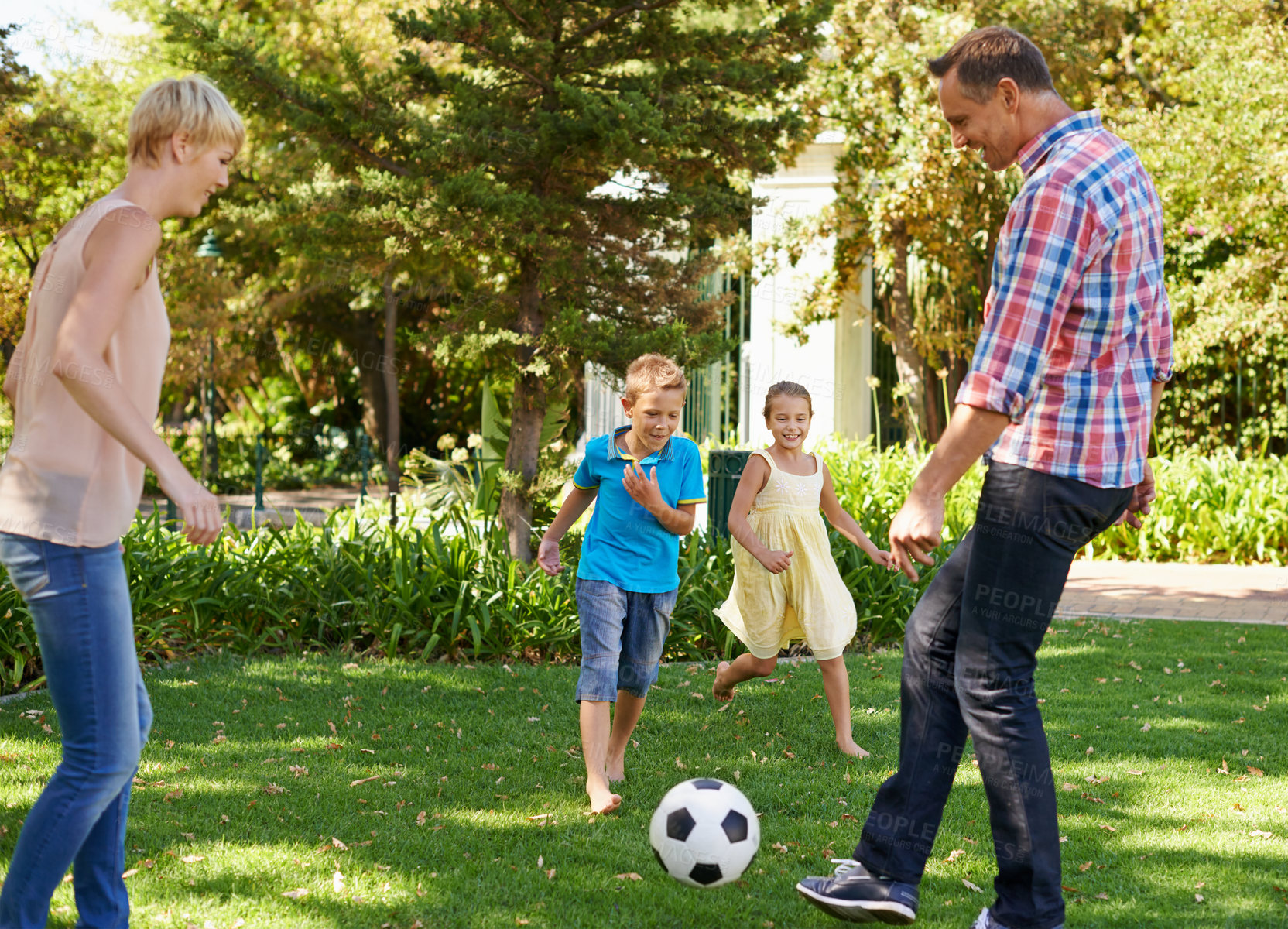 Buy stock photo Parents, children and ball in park as family, playing and bonding together with sport. Kids, son and daughter with mother and father in nature for leisure, childhood development with happiness