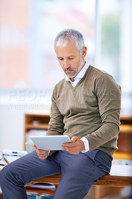 Buy stock photo Online, tablet and businessman in office for research on finance statistics on internet. Serious, reading and mature financial planner work on budget project with digital technology in workplace.
