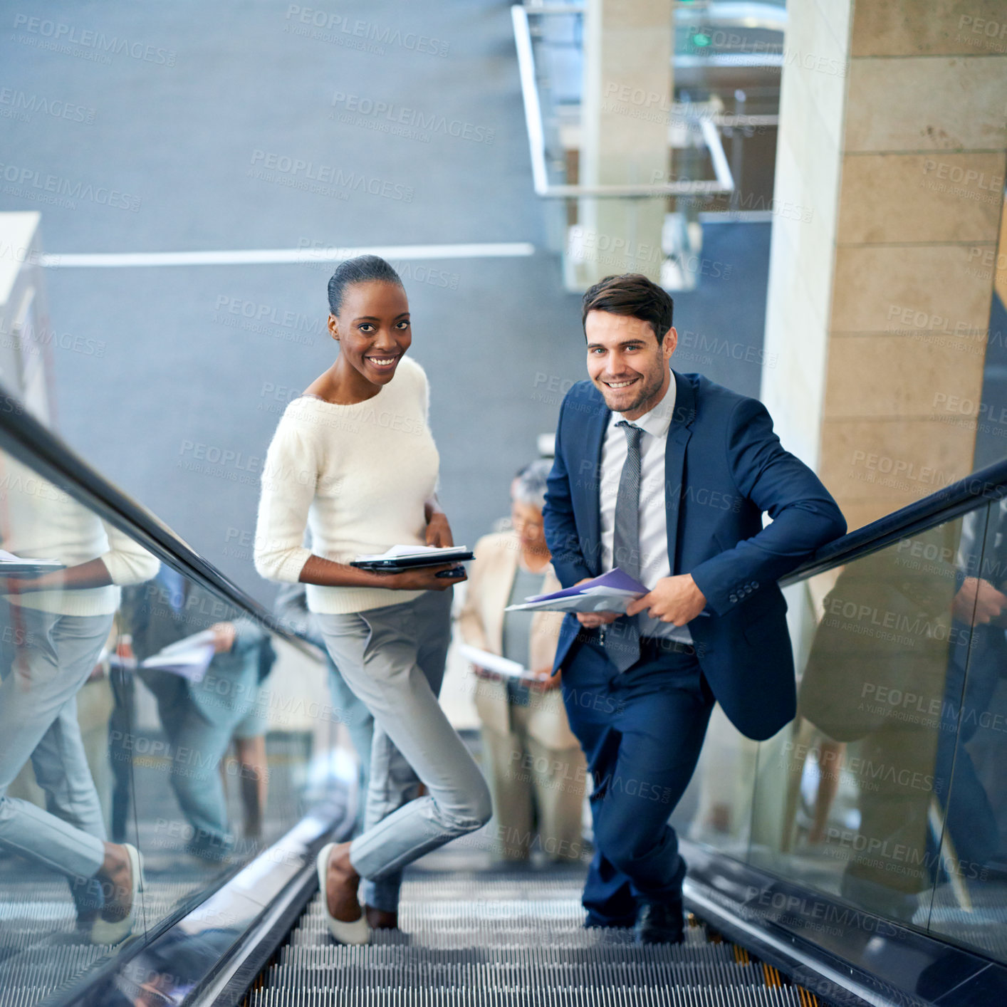 Buy stock photo Teamwork, portrait or business people on escalator for meeting, travel or paperwork in workplace. Diversity, documents and workers planning for collaboration or project together in office with smile