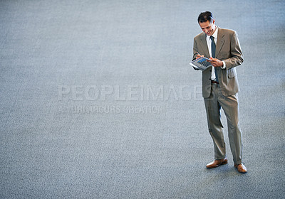 Buy stock photo Full length shot of a businessman standing in a lobby