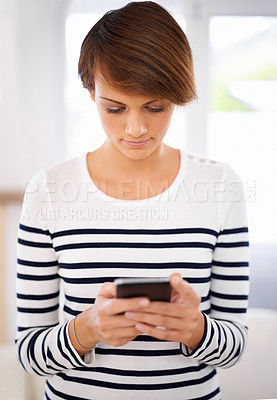 Buy stock photo Cellphone, typing and woman in living room networking on social media, mobile app or internet. Reading, technology and female person scroll on website with phone in lounge at modern apartment.