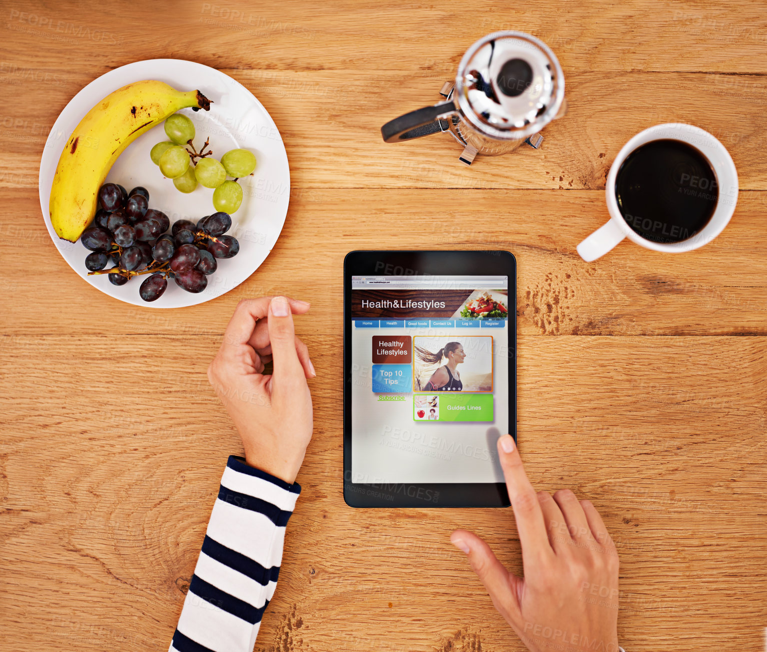 Buy stock photo Shot of an unrecognisable person using a digital tablet at a table