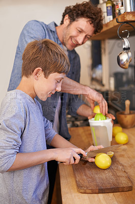 Buy stock photo Father, child and fruit for lemonade in home for nutrition on kitchen counter for breakfast, beverage or diet. Male person, son and juicer tool in apartment or fresh citrus, vitamin c or gut health